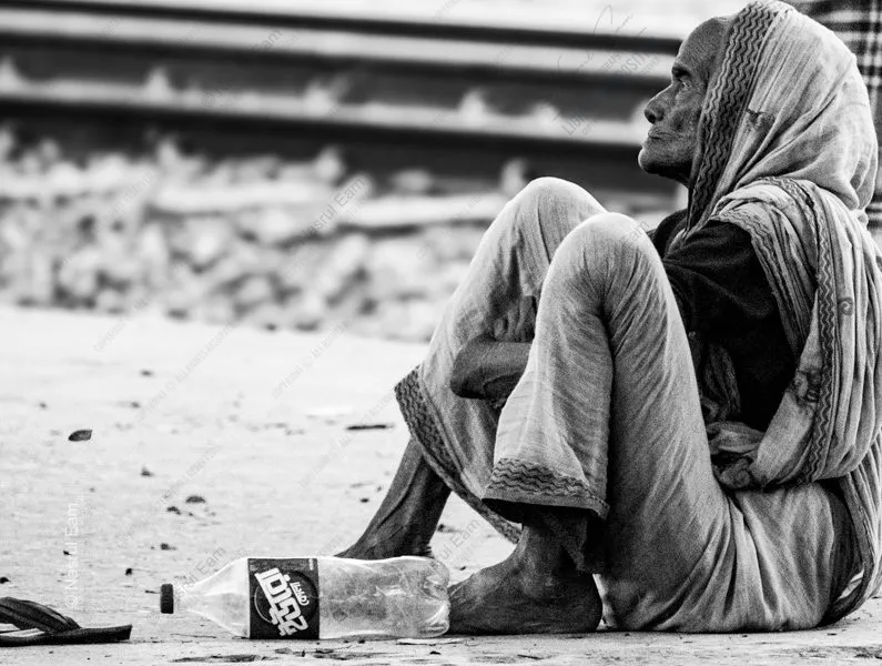 Woman Seated by the Railway Tracks - documentary portraiture, fine art photography, visual storytelling, photography books, photo technique, contemporary journals, human emotion, light and texture