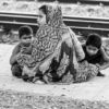 A Family by the Train Tracks - photography composition, documentary portraiture, visual storytelling, photography techniques, human emotion photography
