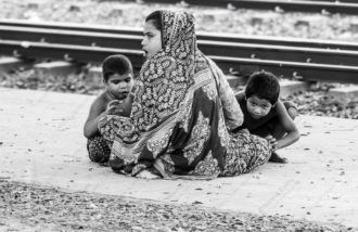 A Family by the Train Tracks - photography composition, documentary portraiture, visual storytelling, photography techniques, human emotion photography
