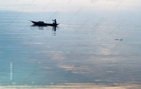 The Oarsman on the Silvered Water - photography composition, visual storytelling photography, light study photography, fine art photography, photo technique tutorials