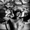 The Porter Under a Sunlit Burden - Visual Storytelling in Photography Books, Documentary Photography Techniques, Monochrome Fine Art Photography, Photography Composition Masterclass, Human Spirit Photography, Photographic Endurance Study