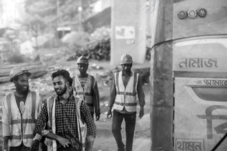 Four Laborers Beside the Namaz Bus - fine art photography prints, visual storytelling photography, human condition art, documentary photography, photography art for collectors