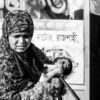 A Mother's Embrace by the Roadside - documentary photography, fine art photography, maternal care art, visual storytelling, portraiture techniques, photography art