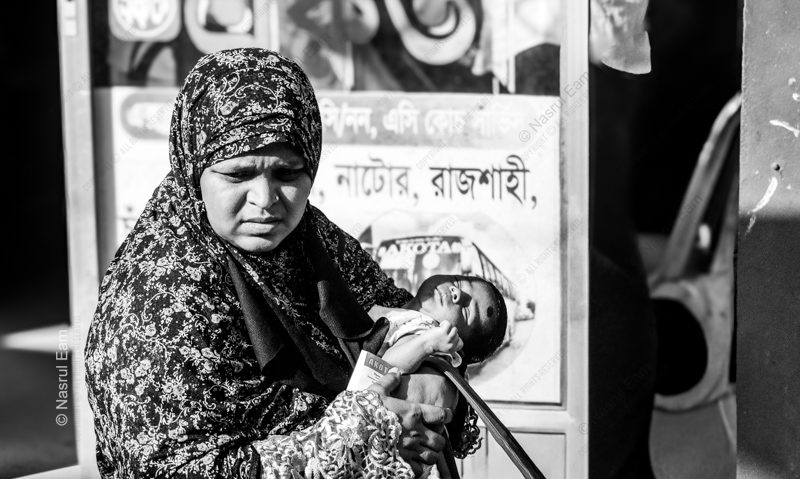A Mother's Embrace by the Roadside - documentary photography, fine art photography, maternal care art, visual storytelling, portraiture techniques, photography art