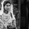 Woman with Folded Arms by a Pillar - Black and white portrait photography, fine art photography prints, visual storytelling photography, contemplative photography, emotional portraiture