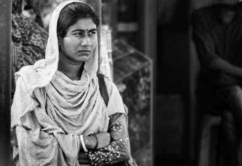 Woman with Folded Arms by a Pillar - Black and white portrait photography, fine art photography prints, visual storytelling photography, contemplative photography, emotional portraiture