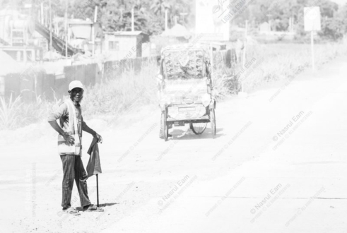 A Road Worker with His Flag - fine art photography, photography art prints, visual storytelling photography, documentary photography books, photography technique tutorials