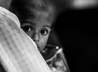 A Child's Gaze from a Protector's Shoulder