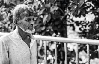 An Elder by the Railing