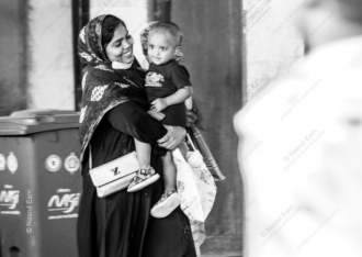 A Woman's Smile, Her Child in Arms