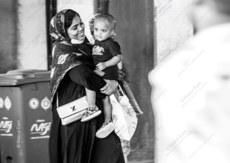 A Woman's Smile, Her Child in Arms