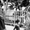 An Elder, a Woman, and a Child by the Roadside