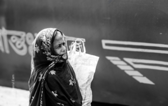 Woman Waiting by a Painted Hull