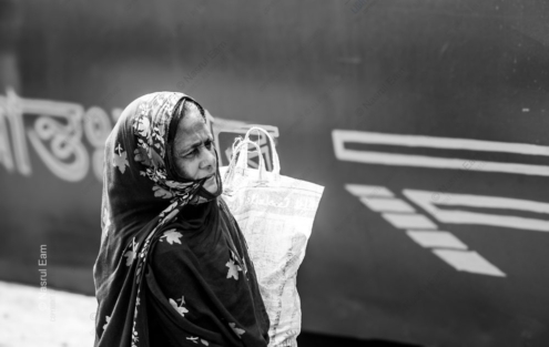 Woman Waiting by a Painted Hull
