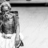 An Elder Seated on the Pavement