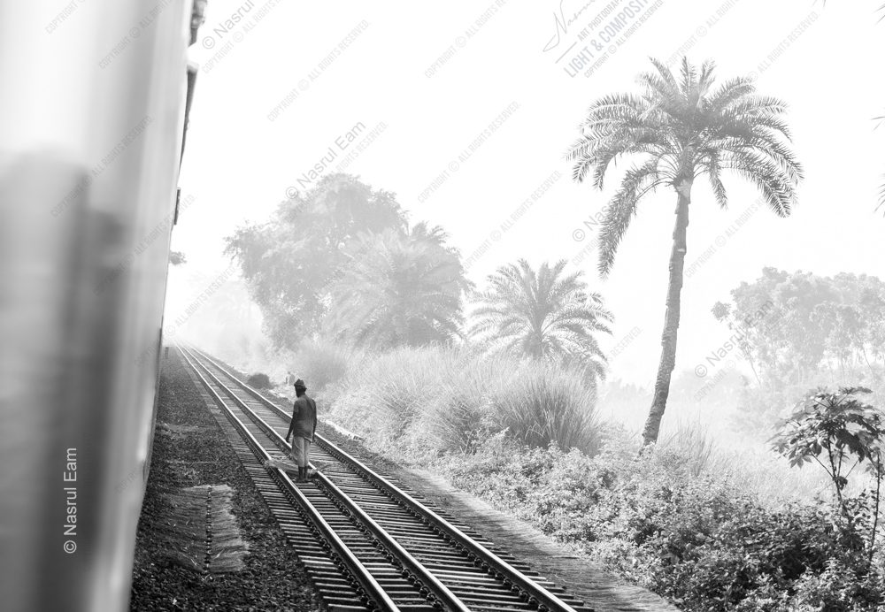 A Lone Walker on the Tracks in the Mist