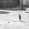 Boy in the Sunlit Drying Yard