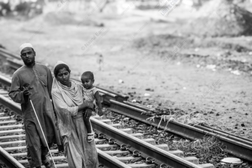 A Blind Man and His Family on the Tracks