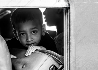 Young Traveler by the Window