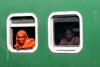Woman in Orange and Girl in the Window