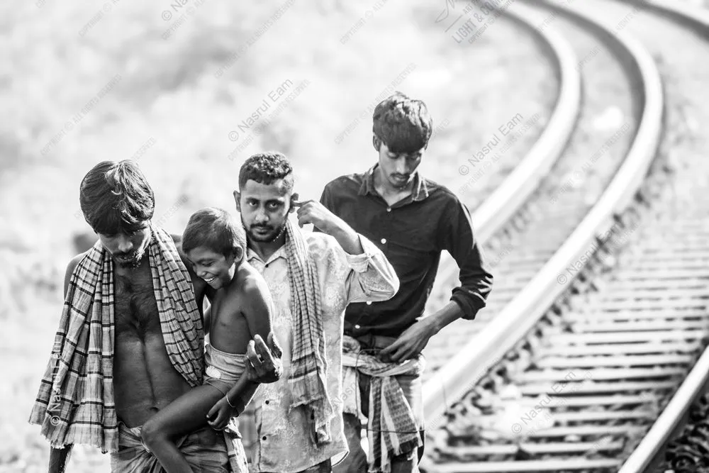 Men and a Child Beside the Tracks