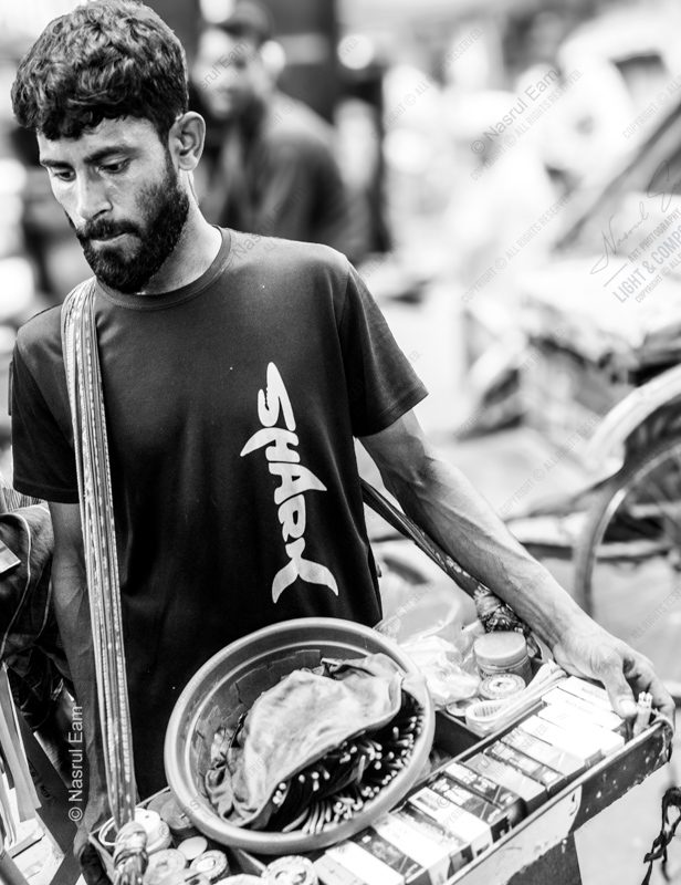 The Young Vendor's Downward Gaze