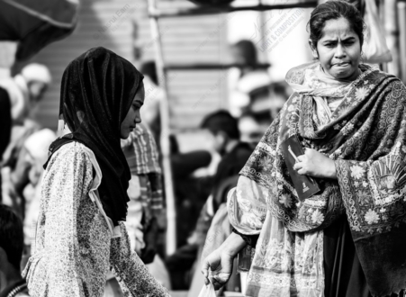 Two Women in Conversation at the Market