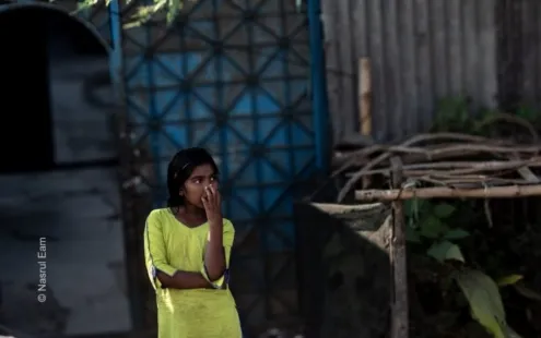 A Young Girl's Quiet Gaze by the Blue Gate