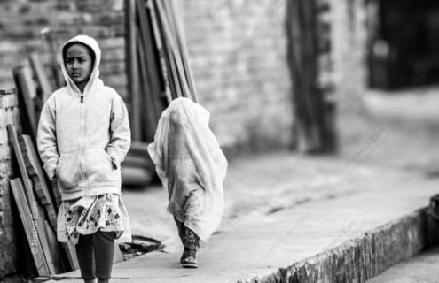 Two Children Walking Along a Dusty Path