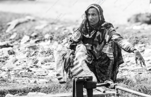 Woman Resting Beside the Tracks