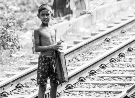 Young Boy Standing on the Railway Tracks